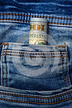 100 dollar bills in blue jeans pocket 2