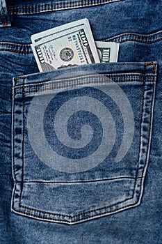 100 dollar bills in blue jeans pocket 3