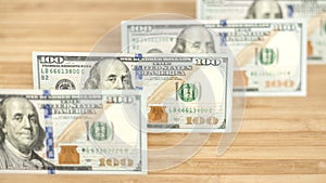 100 Dollars bill and portrait Benjamin Franklin on USA money banknote. Hundred dollar bills on wooden background