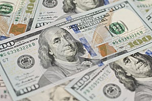 100 Dollars bill and portrait Benjamin Franklin on USA money banknote. Hundred dollar bills on wooden background