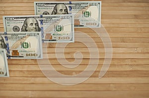 100 Dollars bill and portrait Benjamin Franklin on USA money banknote. Hundred dollar bills on wooden background