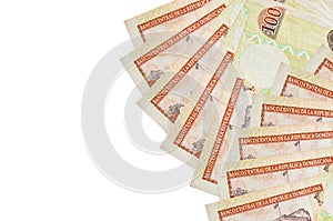 100 Dominican peso bills lies isolated on white background with copy space. Rich life conceptual background