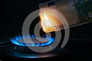 100 euro banknote on a gas burner. The concept of cost for natural gas. Energy crisis. High cost, gas price. Sanctions