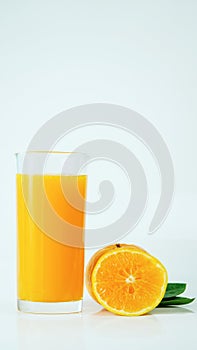 100% fresh-squeezed orange juice in a glass And citrus fruit split on white background. Concept of how to live with a naturally