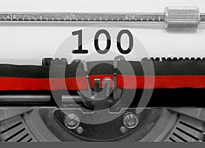 100 Number by the old typewriter on white paper