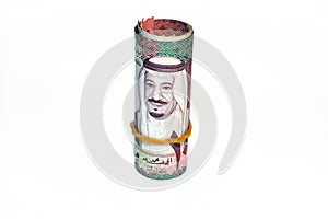 100 one hundred Saudi Arabia money roll riyals banknotes isolated on white background, Saudi riyals cash money bills rolled up