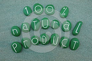 100 percent natural product, slogan with green painted stones over green sand