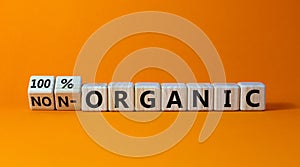 100 percent organic symbol. Fliped wooden cubes and changed words non-organic to 100 percent organic. Beautiful orange background