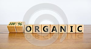 100 percent organic symbol. Fliped wooden cubes and changed words `organic` to `100 percent organic`. Beautiful wooden table,