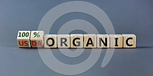 100 percent organic symbol. Fliped wooden cubes and changed words USDA organic to 100 percent organic. Beautiful grey background,