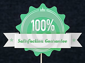 100% satisfaction guarantee badge cut from cardboard