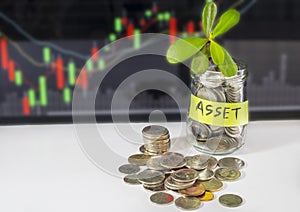 100 US dollars bank notes and money coins. with money in jar against stock market abstract background.