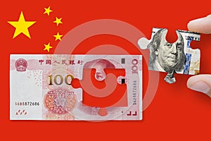 100 yuan note on China flag background with 100 dollar