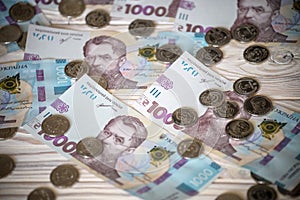 1000 bill ukraine money as background. coin lying on pile of grivna. money concept