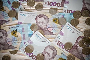 1000 bill ukraine money as background. coin lying on pile of grivna. money concept