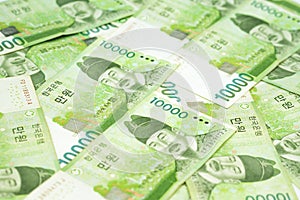 10000 Korea won bills on table as money background. South Korean