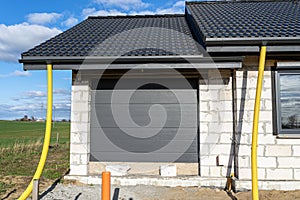 100mm diameter yellow PVC pipe connected to the end of the gutter on the roof, protected against water.