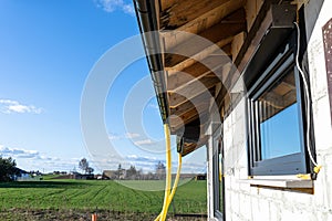 100mm diameter yellow PVC pipe connected to the end of the gutter on the roof, protected against water.