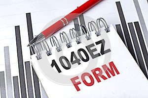 1040 EZ FORM text written on notebook with pen on chart