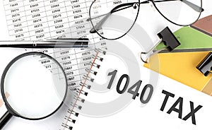 1040 TAX - the inscription of text on the Notepad, and chart. Business concept