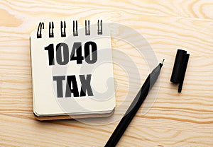 1040 tax text on notepad with paper shee