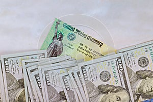 1040 U.S. Individual Income Tax Return, Stimulus economic tax return check and USA currency hundred US dollar bills