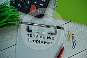 1099 Vs W2 Employee write on a paperwork isolated on office desk