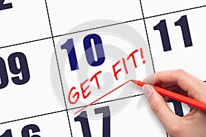 10th day of the month. Hand writing text GET FIT and drawing a line on calendar date. Save the date.