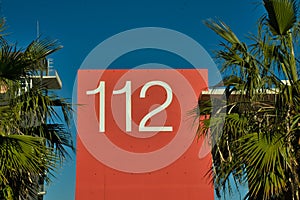 112, emergency number on red background