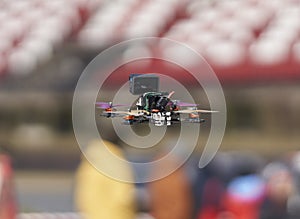 12-05-2022 Riga, Latvia a small camera flying through the air over a field of people in a stadium with a camera attached to the