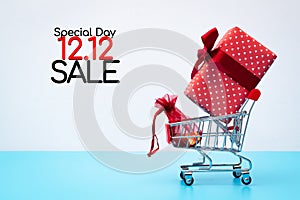 12.12 sale concept, shopping cart and gift box with pocket money