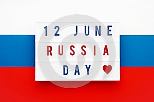 12 JUNE RUSSIA DAY written in lightbox on russian flag background. Independence day date. Top view