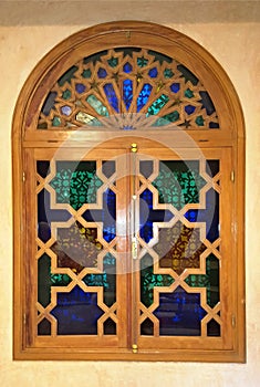 12 March 2019, Marracesh Morocco: Window with a wooden lacquered frame with a glazed mosaic of multicolored glass pieces and a