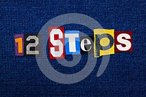 12 STEPS word text collage, multi colored fabric on blue denim, addiction and recovery concept