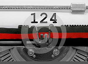 124 Number by the old typewriter on white paper