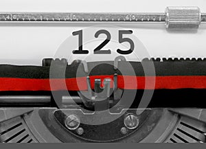 125 Number by the old typewriter on white paper