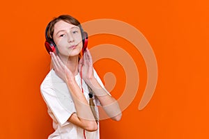 12s girl listens to music on headphones closeup