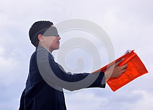 13 year old child with blindfold reading book, on the roof in the rainy season, Indecision and uncertainty conceptual, selective