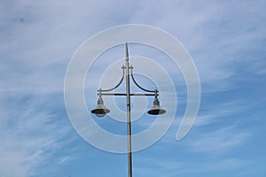 14 April 2023 - United Kingdom: Old fashioned street lamps against blue sky