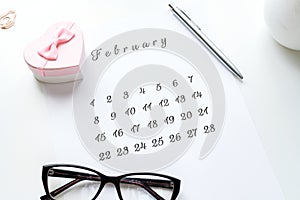 14 February calendar with pink gift heart on top Valentine`s Day card