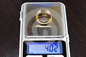 14K gold wedding ring on electronic scale