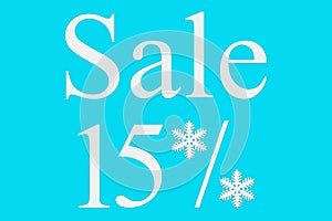 15 percent sale on a blue background, top view. Background for Christmas, new year, and winter sales. Seasonal discounts in stores