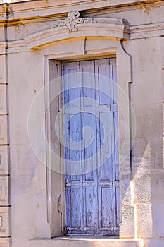 1500\'s building and a wood door with peeling blue paint