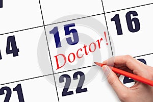 15th day of the month. Hand writing text DOCTOR on calendar date.