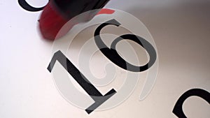 16 - Marking the date in the calendar with a red marker. The sixteenth day of the month. A time limit or deadline is a