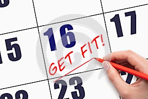 16th day of the month. Hand writing text GET FIT and drawing a line on calendar date. Save the date.