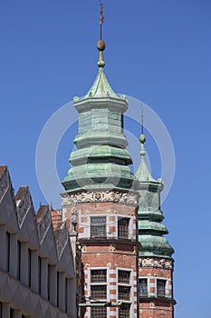 17th century building of Great Armory, arsenal in mannerist style, two towers on a background of blue sky, Gdansk, Poland