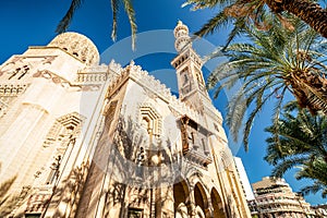 18/11/2018 Alexandria, Egypt, Incredibly beautiful mosque Abo El Abass against blue sky and palm trees