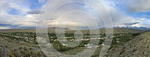 180 degree panorama of the village of Kyzyl Tuu with dramatic sky in Kyrgyzstan