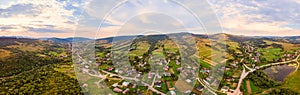 180 degrees panoramic landscape of countryside, aerial drone view of urban village Pidbuzh in Carpathians, Ukraine. Sunset time,